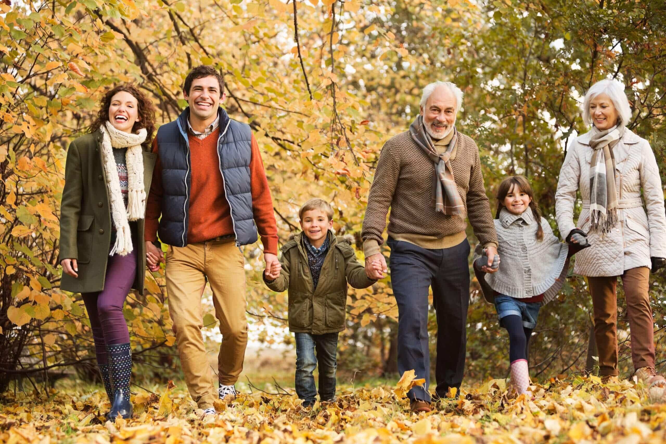 Family enjoying a walk together in an autumn park. Family enjoying a walk together in an autumn park.